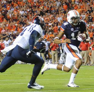 Auburn QB Nick Marshall passed for two scores and ran for two more as he kept his team in contention for the playoffs.