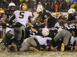 Navy QB Keenan Reynolds dives over from the 1 yard line to lead his team to their 13th straight win over Army.